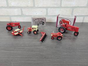 lot 1322 image: ERTL Farmall 300 Replica Series Tractor - 132 Scale, ERTL Toy Farmer 1991 Farm Toy Show Farmall Super M-TA Tractor - 143 Scale and More