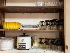 lot 73 image: Contents of Kitchen Cabinets #2 Cake Platter, crockpots, glassware, bowls
