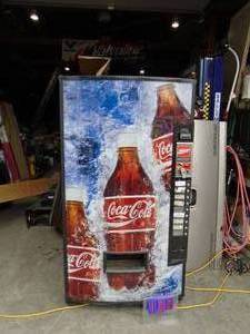 lot 100 image: Vendo Coke Machine. Consigner says was using it till now with key. R134A system. Plastic appears to be in good shape. Heavy unit & you will need to bring help to load as well. We will not help load. As shown.