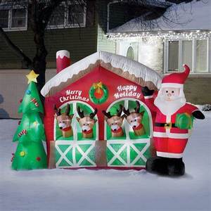 lot 17 image: Animated Santa and House Inflatable 8.5 X 5.5 Long Christmas Inflatable Santa Claus Reindeer in Stable with Christmas Tree