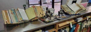 lot 212 image: Contents on Top of Counter - Manuals, Bell, Stanadyne Pump Business Card Holder and More