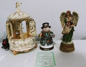 lot 9 image: The Bradford Editions Terry Redlin Winter Wonderland Heirloom Classics, Musical Carousel and Angel