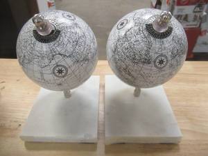 lot 46 image: Litton Lane White Marble Contemporary Globe Bookends 7 in. x 5 in. (Set of 2), Chip on marble base - SOLD AS IS