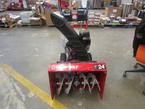 lot 480 image: Troy-Bilt Storm 24 in. 208 cc Two- Stage Gas Snow Blower with Electric Start Self Propelled (HEX SHAFT IS BROKEN AND NEEDS TO BE REPLACED, WHEEL AXLE HOLE IS BENT ON ONE SIDE, OTHERWISE BRAND NEW)