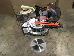 lot 5 image: Ridgid 15 Amp Corded 12 in. Dual Bevel Sliding Miter Saw with 70 Deg. Miter Capacity and LED Cut Line Indicator open box see pictures