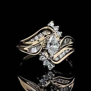 14k Yellow Gold Diamond Ring Features High Quality Marquise Cut Diamond Center Surrounded by Rounds. VS-GH $2950 Retail