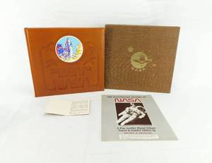 lot 34 image: 1986 The Illustrated History of NASA Leather Bound by Robin Kerrod