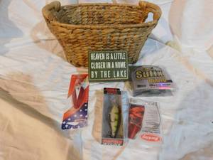 lot 355 image: golf warm up swing & grip trainer, Golf putter, fishing sign (Heaven is a little closer to a home by a lake), 4 rulers with advertisment on them), rapala shad rap fishing lure in box, daredevil in package, fishing line and more