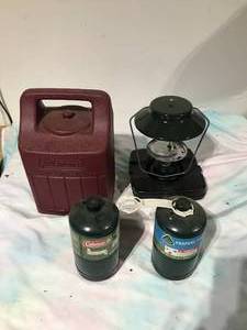 lot 143 image: Coleman Lantern w case and 2 propane tanks