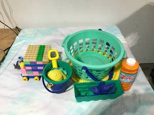 lot 58 image: Legos and sifting basket of sand toys and bubbles