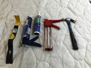 lot 111 image: Wonder bar, hammer and calking guns and caulk