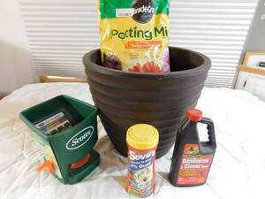 lot 30 image: Lg planter,seeder, potting soil and pesticides 