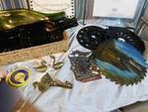 lot 350 image: 2 bags, 2 chair cushions, 2 wine bottles for dcor, saw blade with painted picture on it, 3 brass ducks, minnesota ashtray, wreath and more