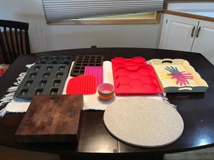 lot 256 image: 2 cutting boards ( one is stone & one is wood), silicone baking molds & cupcake and brownie pans