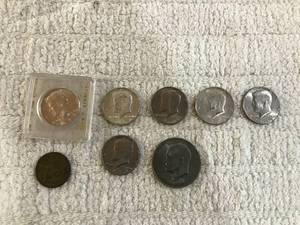 lot 277 image: (8 coins) - (1 - 1971 silver dollar) - (6 - Kennedy half dollars  - 1964, 1969, 1972, 1974, 1976)  - (1 Good years grocery token)