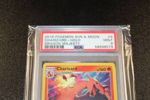 lot 12 image: 2018 Pokemon Sun & Moon Dragon Majesty Charizard Holo #370 PSA 9