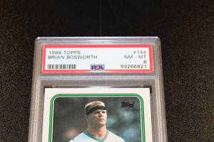lot 129 image: 1988 Topps Brian Bosworth #144 Rookie Card PSA 8