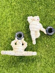 lot 83 image: 2 Cast Iron Michelin Man Figures 2  & 3 Inch