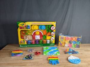 lot 163 image: Assorted Pop and Spinner Fidget Toys, Play Doh 12-Pack, and Crayola Dough Barnyard Play Center M