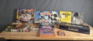 lot 164 image: Collection of Newer and Vintage Games and Toys - WWE StackDown Toy, Pictionary, Yu-Gi-Oh Trading Card Game, Anime Pins, Gilbert Microscope Set, Clue, NASCAR Monopoly, Tarot Discovery Set, Uno M