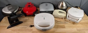 lot 185 image: Kitchen Essentials GE Waffle Maker, George Forman Grill, Cuisinart Egg Cooker, Proctor & Silex Hand Mixer, Betty Crocker Waffle Baker, Toastmaster Sandwich Maker & More M
