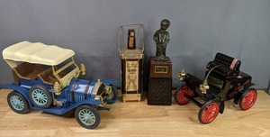 lot 211 image: Vintage Liquor Collectibles  Park & Telford Liquor Bottle HolderMusic Box, (2) Jim Beam Cars, Masterpiece Liquor Dispenser  M