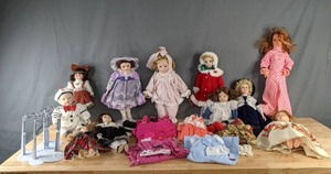 lot 242 image: Collection of (11) Dolls, Doll Clothes and Doll Stands  M