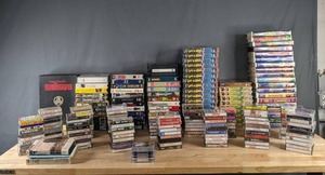 lot 269 image: Huge Assortment of VHS Tapes, Cassette Tapes, and Audiobooks Disney Cartoon Movies, Lost in Space, Little House on the Prairie, Bee Gees, Staler Brothers, New Kids on the Block, and More  M