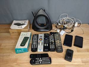 lot 324 image: Assortment of Electronics Philips, Sony, Sanyo, Samsung Remotes, RadioShack, Cell Phone Chargers, USB Charging Boxes and More M