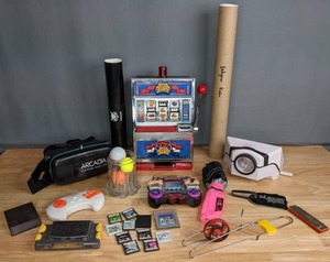 lot 319 image: Games Lot  Nintendo DS Games, Arcadia Virtual Reality 360, Smartphone Projector, Radica Mega Million Slot Machine, and More  M
