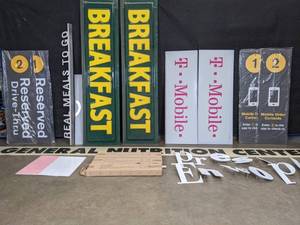lot 53 image: Assortment of SignsBanners T-Mobile, Breakfast, To Go Metal Signs, Grey Signs and More E