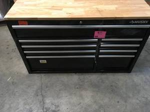 lot 46 image: Husky 52 in. W x 25 in. D Standard Duty 9-Drawer Mobile Workbench Tool Chest with Solid Wood Top in Gloss Black Customer Returns See Terms on Auction