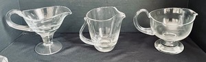 lot 482 image: Trio of Glass Pitchers and 7 Swirled Iridescent Bowls