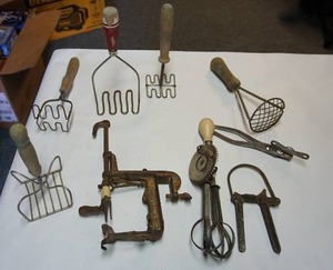 lot 101 image: Vintage kitchen utensilspotato mashers, Apple peeler etc.