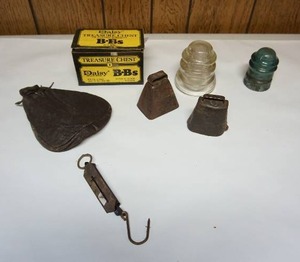 lot 136 image: ManCaveBox of Daisy BBs, Glass Insulators, Cow Bells, Hanging Scale, Ammo() Pouch