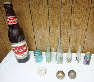 lot 139 image: The Mancave25 Plastic Schmidt Beer Bank, 1975 St. Urhos Brew 12oz T125, Collectible Bottles Etc.