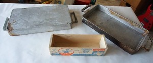 lot 265 image: Wood Cheese Box and Two Great River Aluminum Foundry Sartell, Minnesota Cast Aluminum Baking Pans