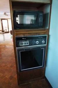 lot 366 image: Appliances including Amana stove top, Whirlpool oven, Sharp microwave, under cabinet radio