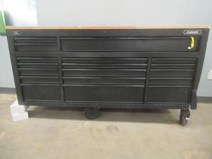 Husky 72 in. W x 24 in. D Heavy Duty 18-Drawer Mobile Workbench Tool Chest with Adjustable-Height Hardwood Top in Matte Black (MISSING 1 CASTER, DAMAGED ON 1 SIDE, DENTED ON THE OTHER, ALL DRAWERS OPEN, DAMAGED SIDE DOES NOT LOCK, CHIPS ON TOP IN WOOD)