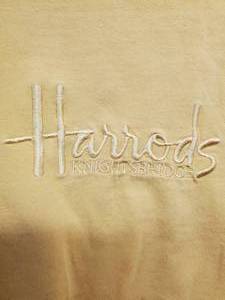 lot 103 image: Harrods Knights Bridge Embroidered Logo Gold T-Shirt Small