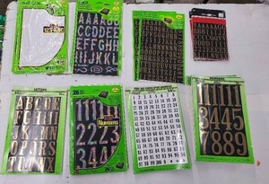 Multiple packages of adhesive letters and numbers