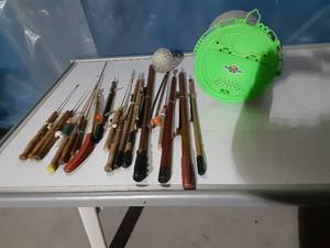 lot 69 image: Lots of vintage ice fishing sticks and minnow bucket
