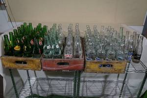 lot 242 image: 3 Vintage Shipping Crates with Assorted Glass Bottles