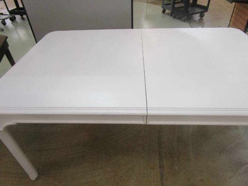 lot 555 image: 72 in White Wooden Table (TABLE ALSO HAS 40 IN LEAF, COUPLE SCUFFS & SCRATCHES ON THE TOP)