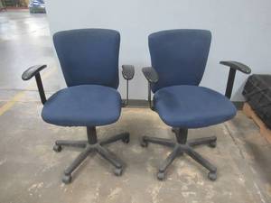 lot 64 image: (2) Office Chairs on casters with adjustable Height - Some Staining on Upholstery, Slight Damage to arm rests, Used in Warehouse, SOLD AS IS.
