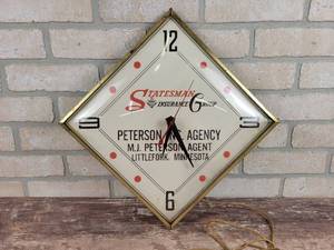 lot 211 image: Vintage Statesman Insurance Group Electric Wall Clock - Approx. 12 x 12 - Peterson Ins. Agency, Littlefork MN