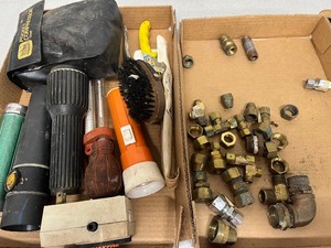 Flat of brass fittings and flat of flashlights