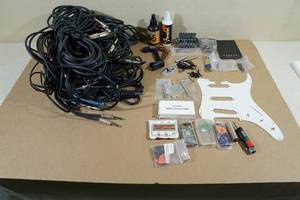 lot 65 image: Assorted Guitar Accessories -Cords, Tuner, Picks, Cleaner & Polish