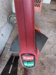 Toro Electric Lawn Trimmer, B & D 8214 Electric Sidewalk EdgerTrimmer, and a Set of Lawn Trimmer Wheels
