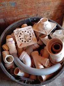 Plastic Can Full of New and Used Plastic Plumbing Pipe and Hardware-including Drains, Elbows, Ys and More